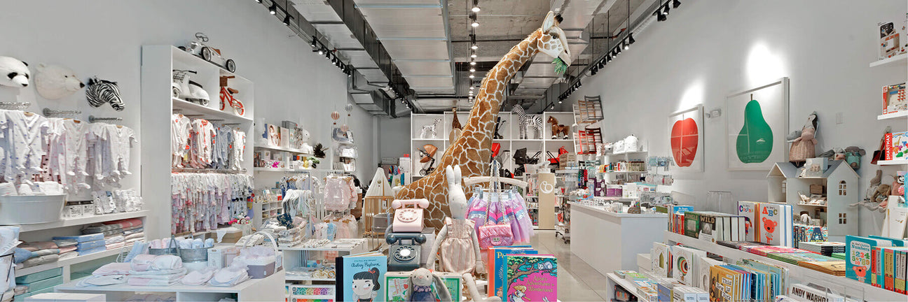 Interior of NINI and LOLI baby store in Miami showing strollers, car seats and nursery furniture